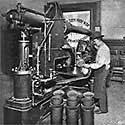 Operator with pneumatic mail machine and carrier tubes.