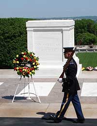 Honor guard marching in front of the Tomb of the Unknowns at Arlington National Cemetary.