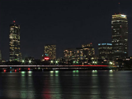 Photo of Massachusetts Avenue bridge at night with Boston skyline in background